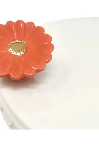 Orange flower-shaped object on a white background