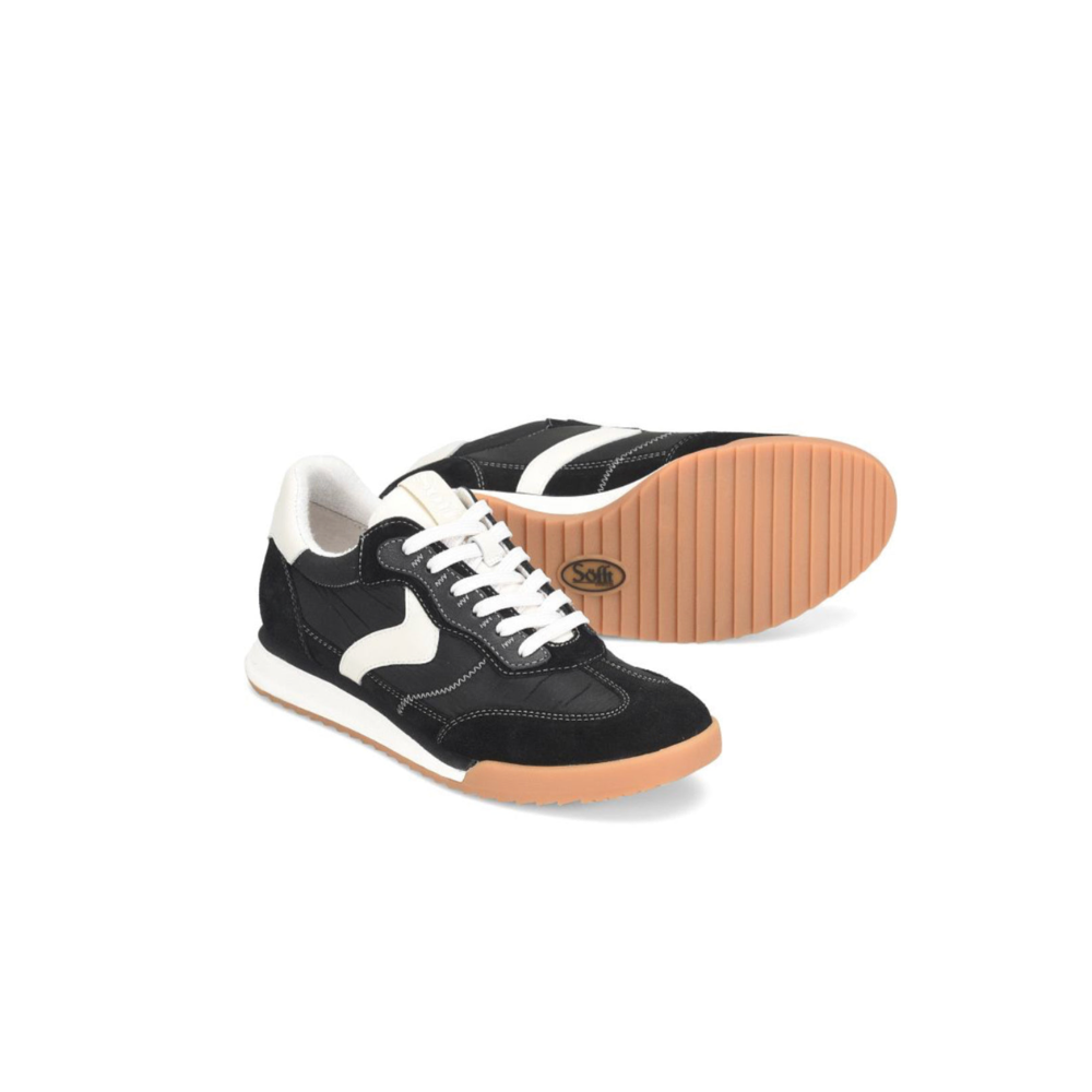 Black and white sneakers with brown soles on a white background