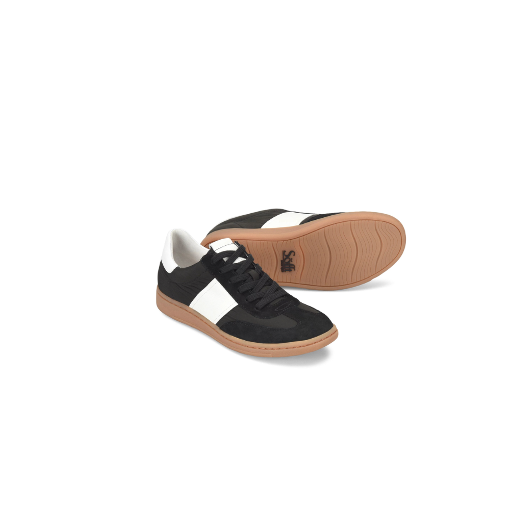 Black and white sneaker with brown sole on a white background