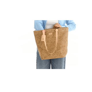 Person holding a brown textured tote bag on a white background