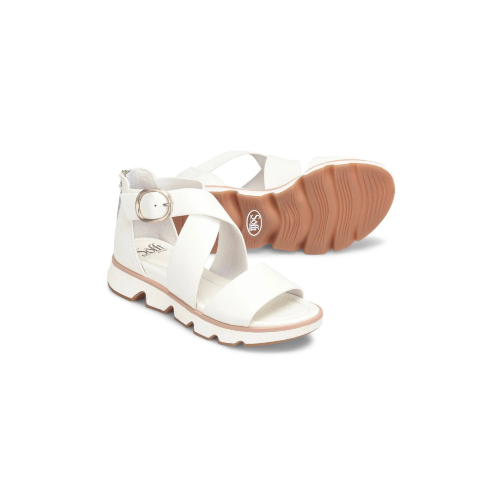 White sandals with brown soles on a white background