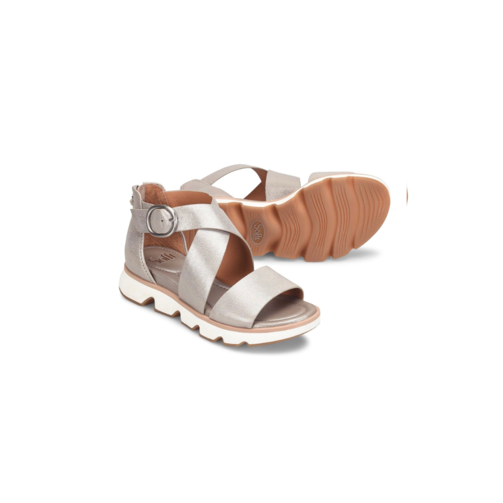 Pair of silver sandals with brown soles on a white background