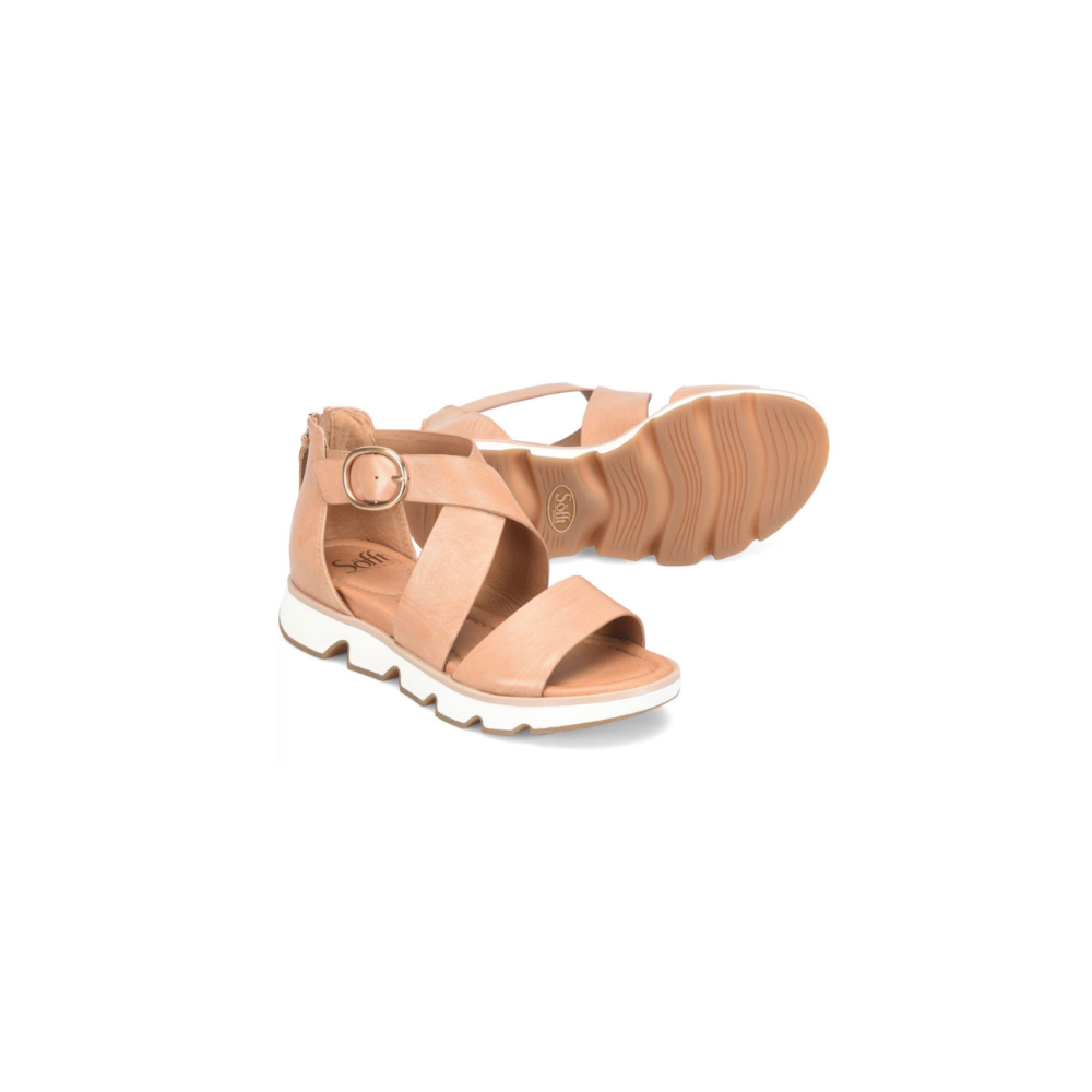 Pair of tan sandals on a white background