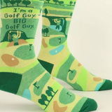 Golf-themed socks with green and yellow design on a white background