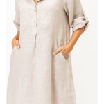 Beige button-up dress worn by a person on a white background