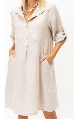 Beige button-up dress worn by a person on a white background