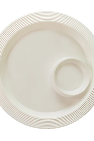 White ceramic plate with concentric circle design on a white background
