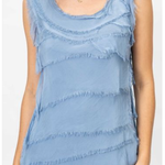 Blue tiered dress worn by a person on a white background
