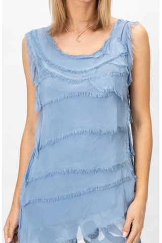 Blue tiered dress worn by a person on a white background