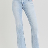 Light blue jeans worn by a person on a plain background