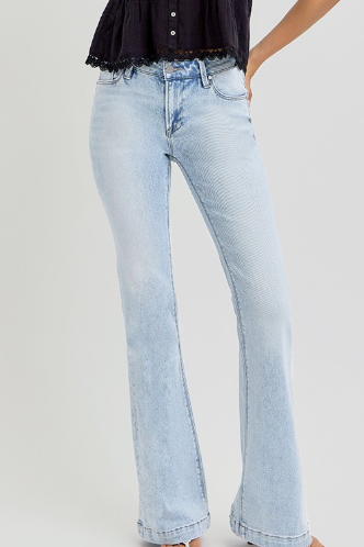 Light blue jeans worn by a person on a plain background
