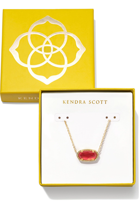 Kendra Scott necklace with red pendant in a yellow box