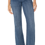 Blue jeans worn by a person on a white background