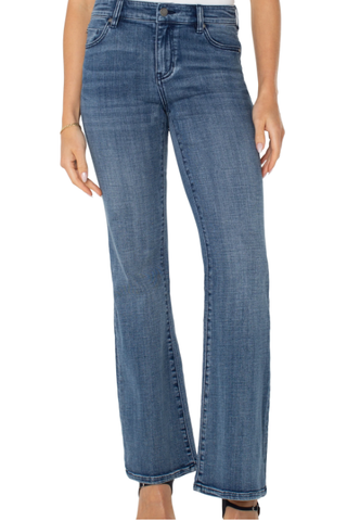 Blue jeans worn by a person on a white background