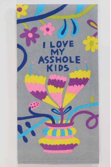 A towel with a colorful floral and ass-related design, text reading 'I LOVE MY ASSHOLE KIDS' on it.