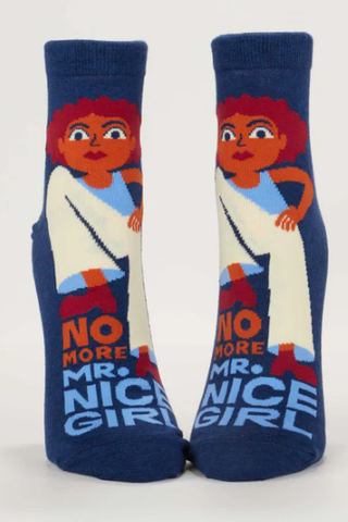 Pair of socks with a design of a person with red hair and text 'No More Mr. Nice Girl' on a white background.