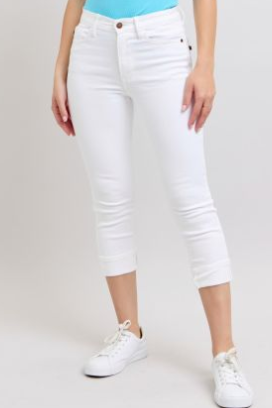 Person wearing white capri pants on a plain background