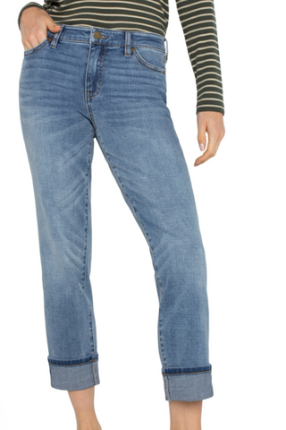 Blue jeans worn by a person on a white background