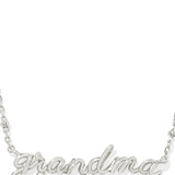 A silver-colored Grandma necklace with a crystal embellishment on the pendant, designed in a cursive script.