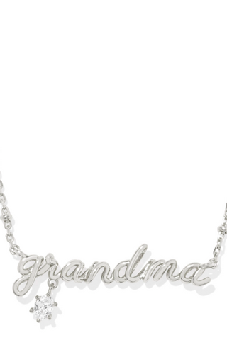 A silver-colored Grandma necklace with a crystal embellishment on the pendant, designed in a cursive script.