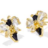 Gold and black earrings with clear stones on a white background
