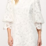 White lace dress with long sleeves on a white background