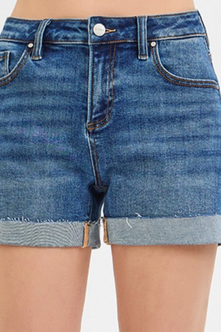 A pair of high-waisted, wide cuffed denim shorts