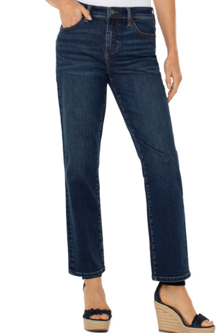 Person wearing dark blue jeans on a white background