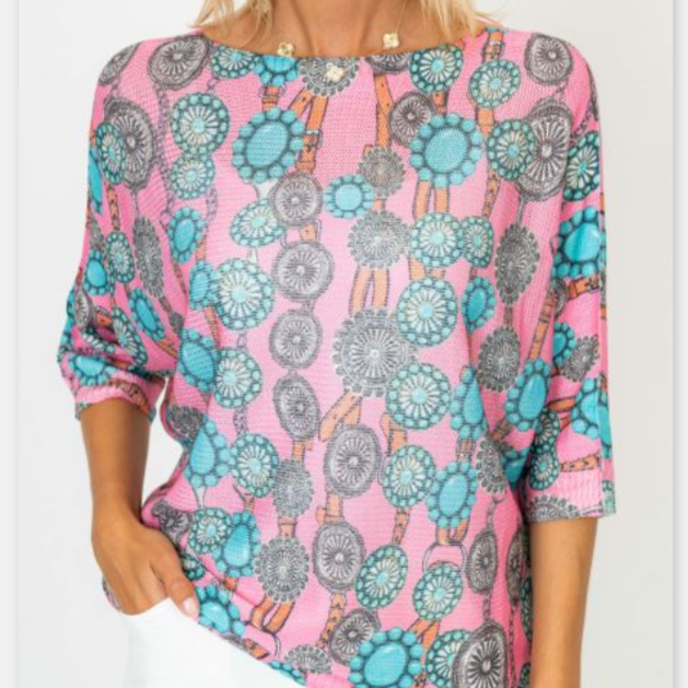 Pink blouse with blue and gray pattern worn by a person