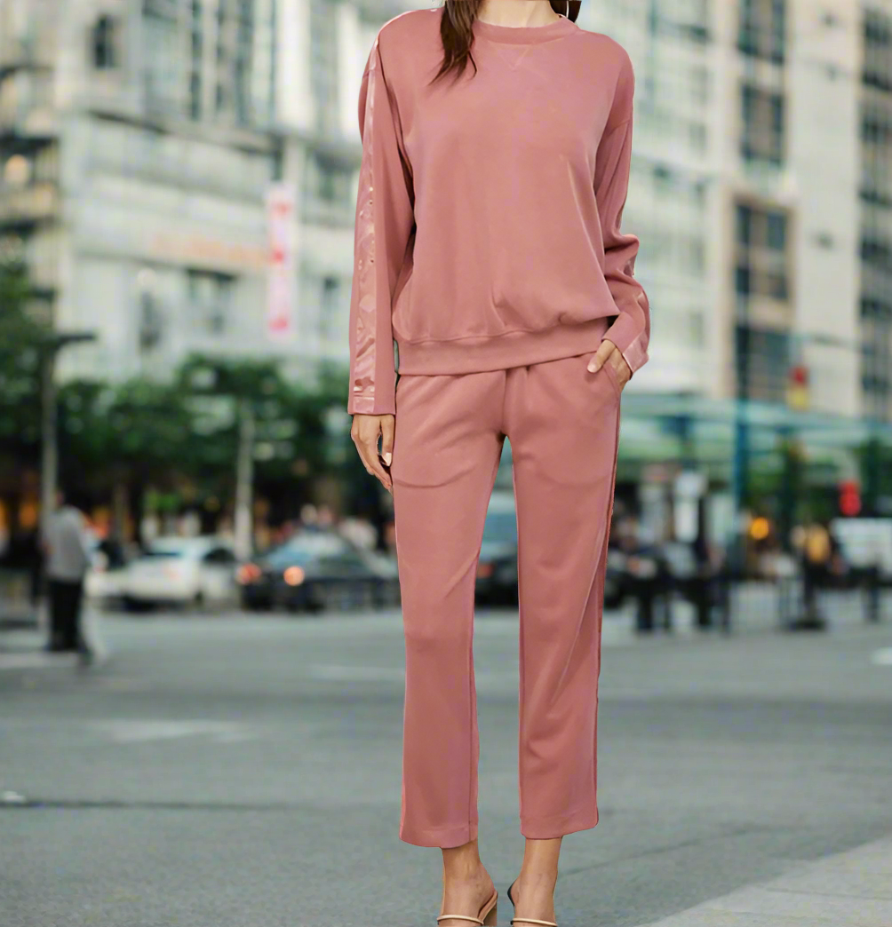 Person wearing a pink outfit on a city street