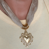 Necklace with a heart-shaped pendant on a neutral background