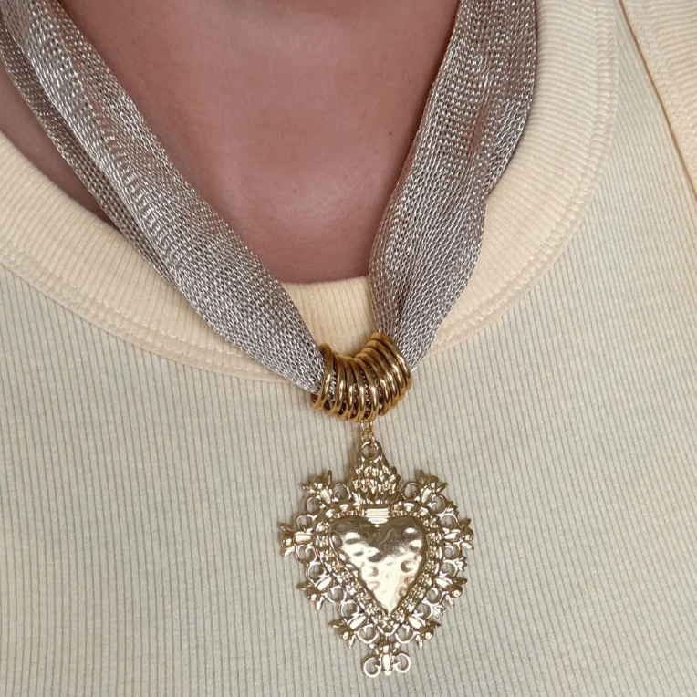 Necklace with a heart-shaped pendant on a neutral background