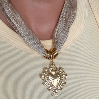 Necklace with a heart-shaped pendant on a neutral background