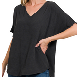 Woman wearing a black oversized t-shirt on a white background