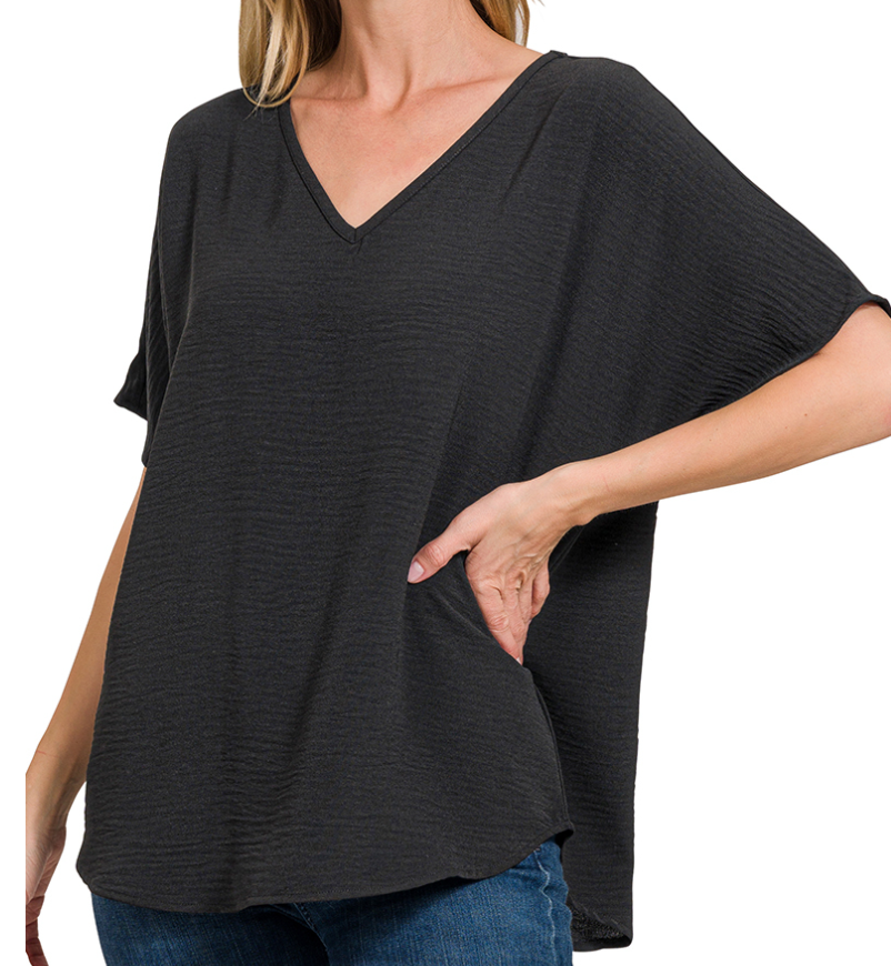 Woman wearing a black oversized t-shirt on a white background