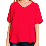 Red blouse worn by a person on a white background