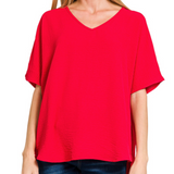 Red blouse worn by a person on a white background