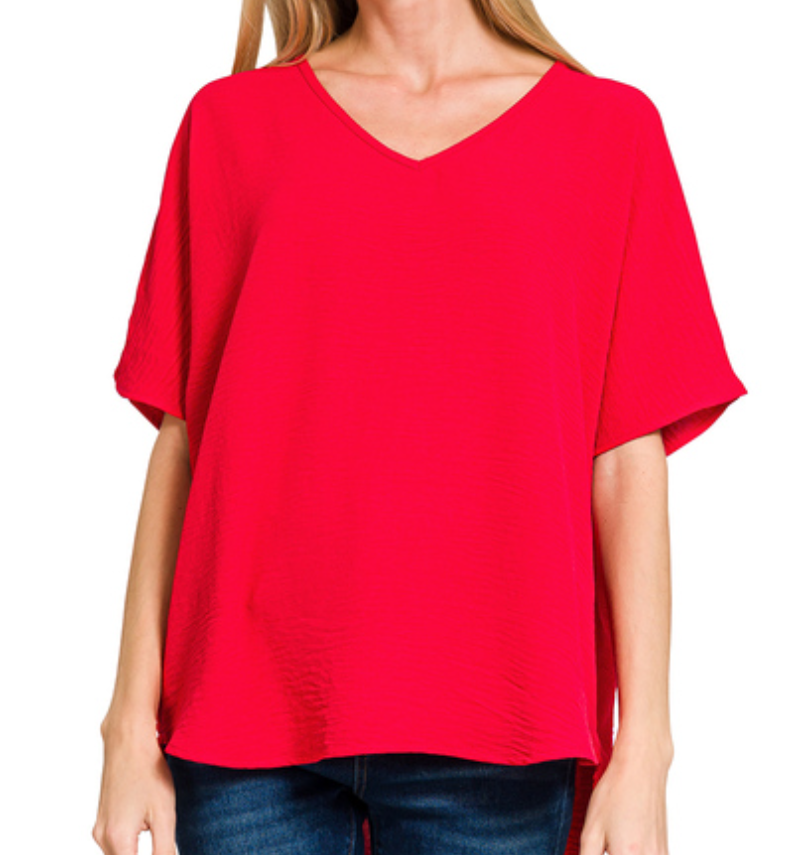 Red blouse worn by a person on a white background