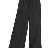 Black wide-leg pants with a drawstring waist on a white background