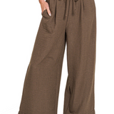 Brown wide-leg pants with drawstring waist on a white background