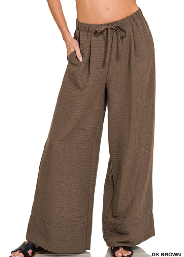 Brown wide-leg pants with drawstring waist on a white background