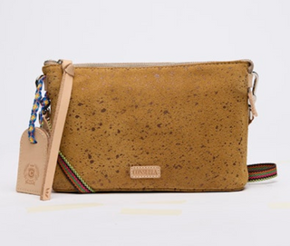 Brown cork handbag with a strap on a light gray background