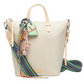 Beige woven handbag with colorful strap and decorative charms on a white background