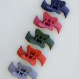 Set of colorful hair clips on a white background