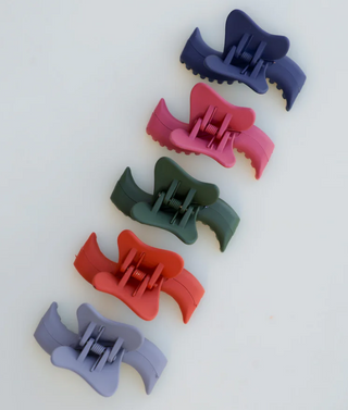 Set of colorful hair clips on a white background
