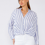 Woman wearing a blue and white striped shirt against a white background
