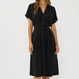 Woman wearing a black dress against a white background