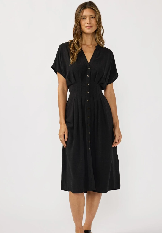 Woman wearing a black dress against a white background