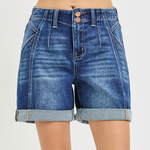 Blue denim shorts on a plain background