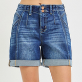 Blue denim shorts on a plain background